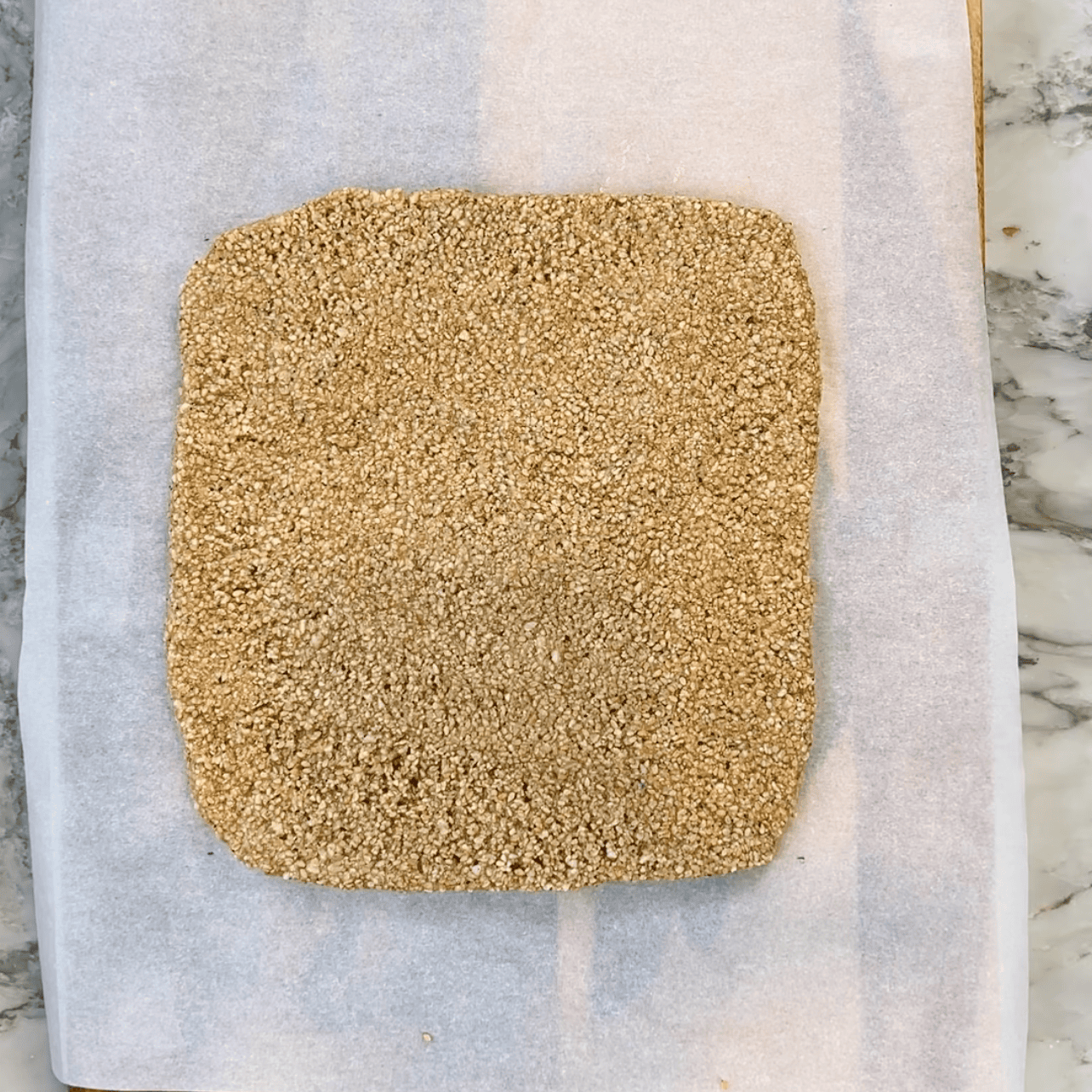 til vadi mixture spread into a square on a parchment paper.