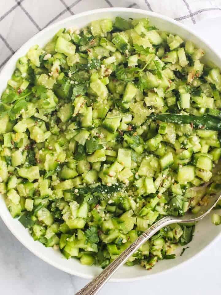 cucumber salad in a white bowl