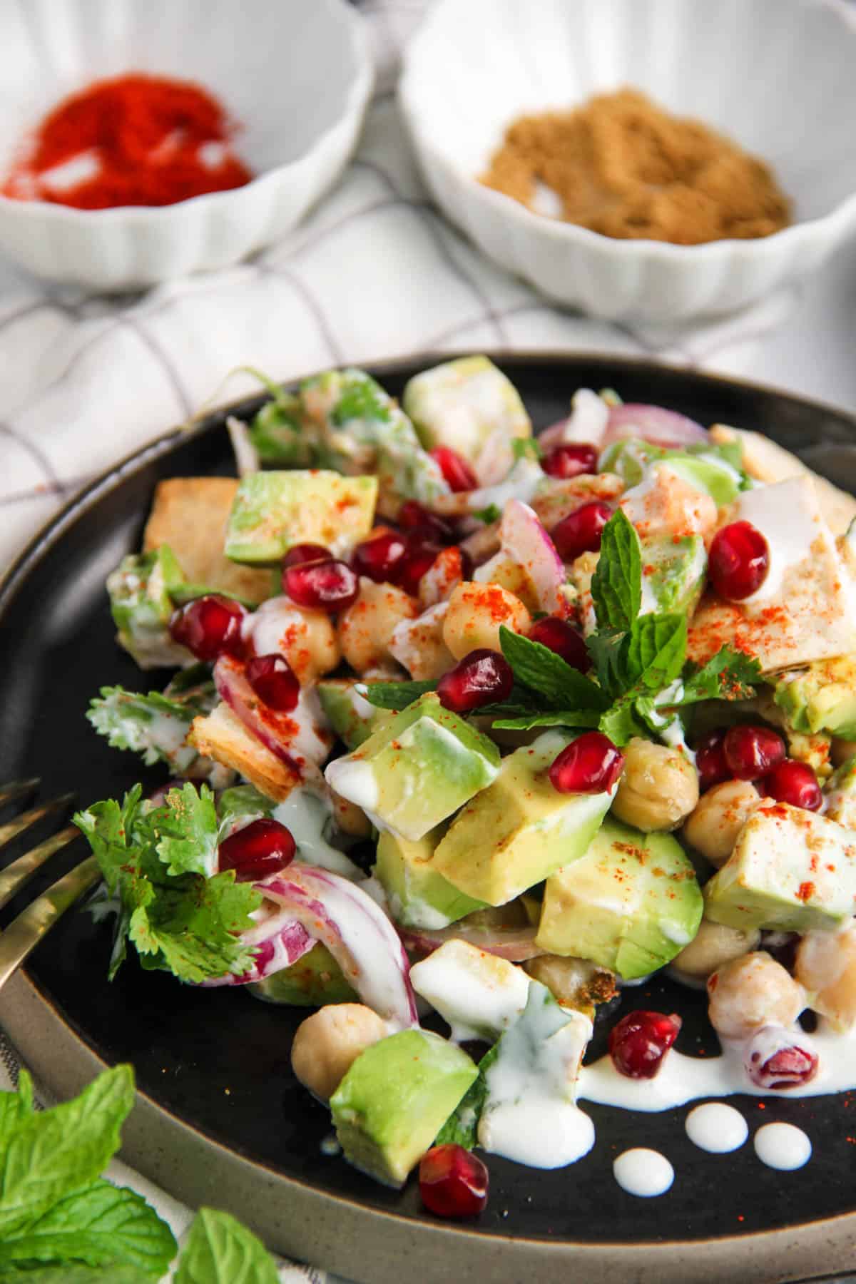 avocado chickpea salad served in a black plate