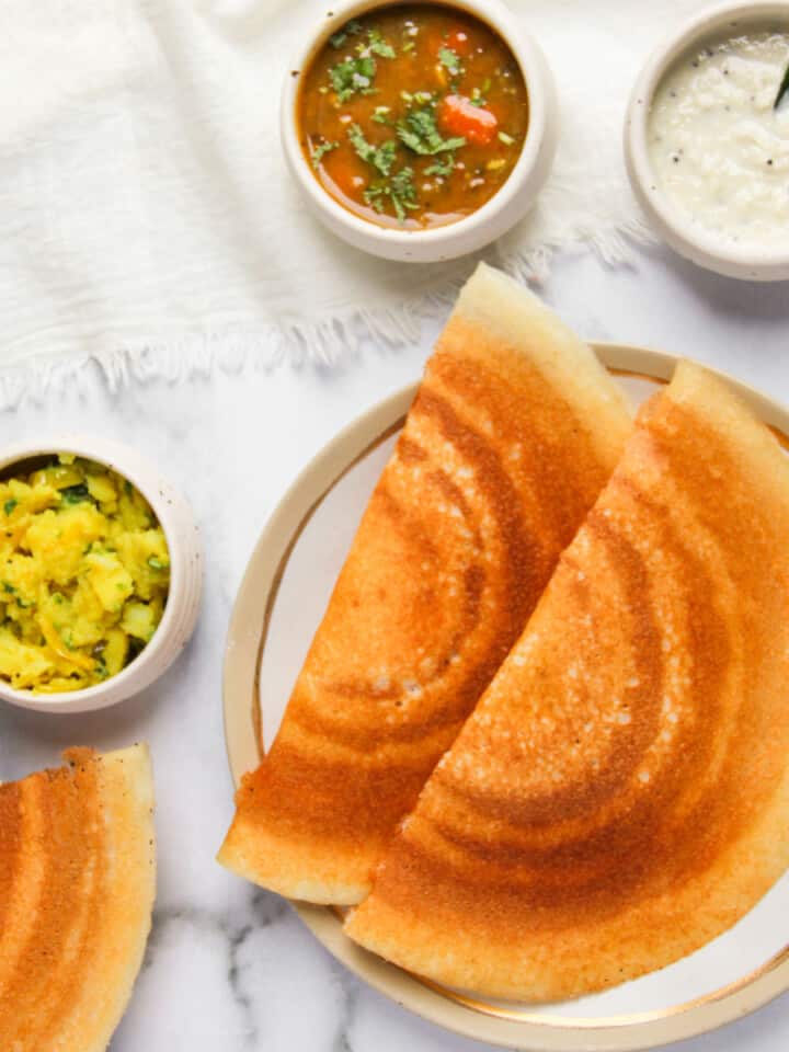 crispy dosa served with sambar, chutney and spicy potatoes