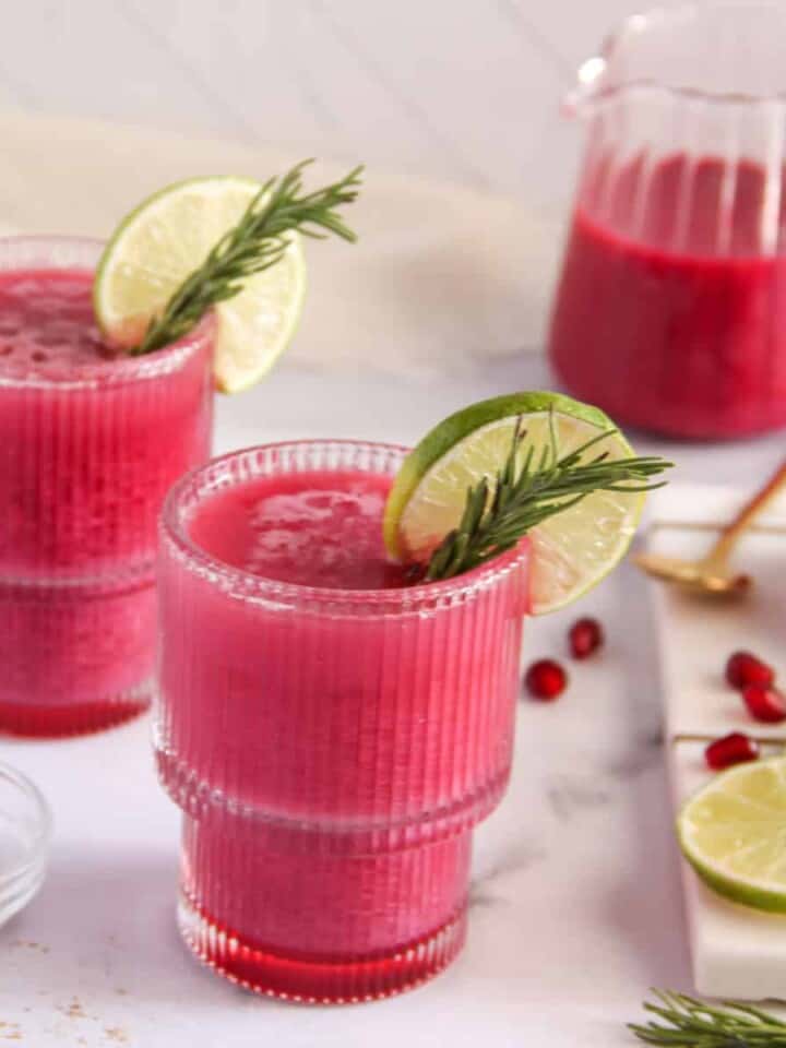pomegranate spritzer garnished with roasemary and lime