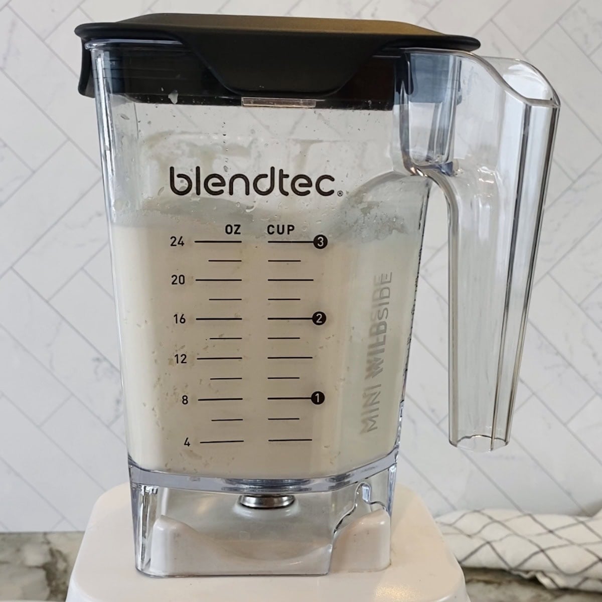 A Blendtec blender jar filled with a rice batter.