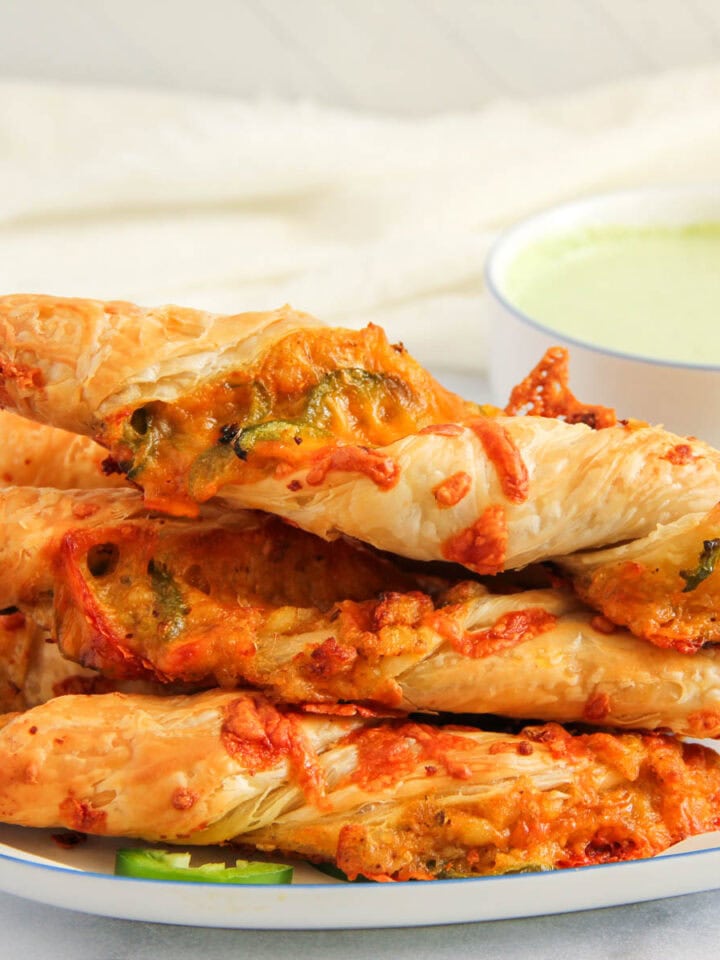 stacked Jalapeño Cheese Samosa Twists on a platter.