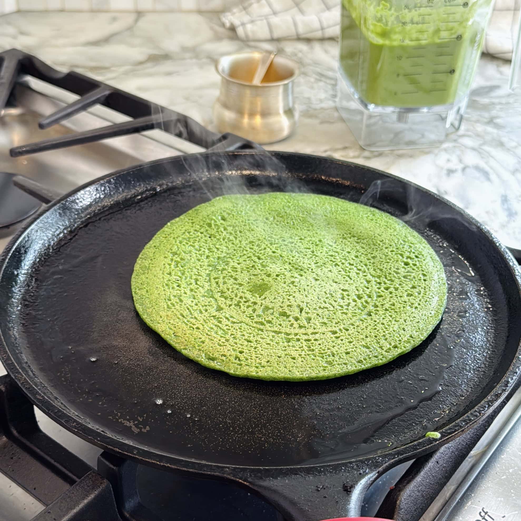 cooked spinach chilla on a pan.
