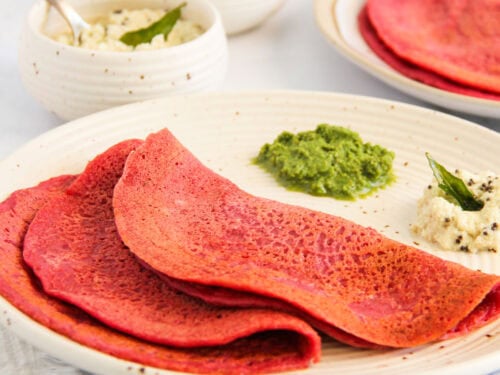 beet chillas served with cilantro chutney and coconut chutney.