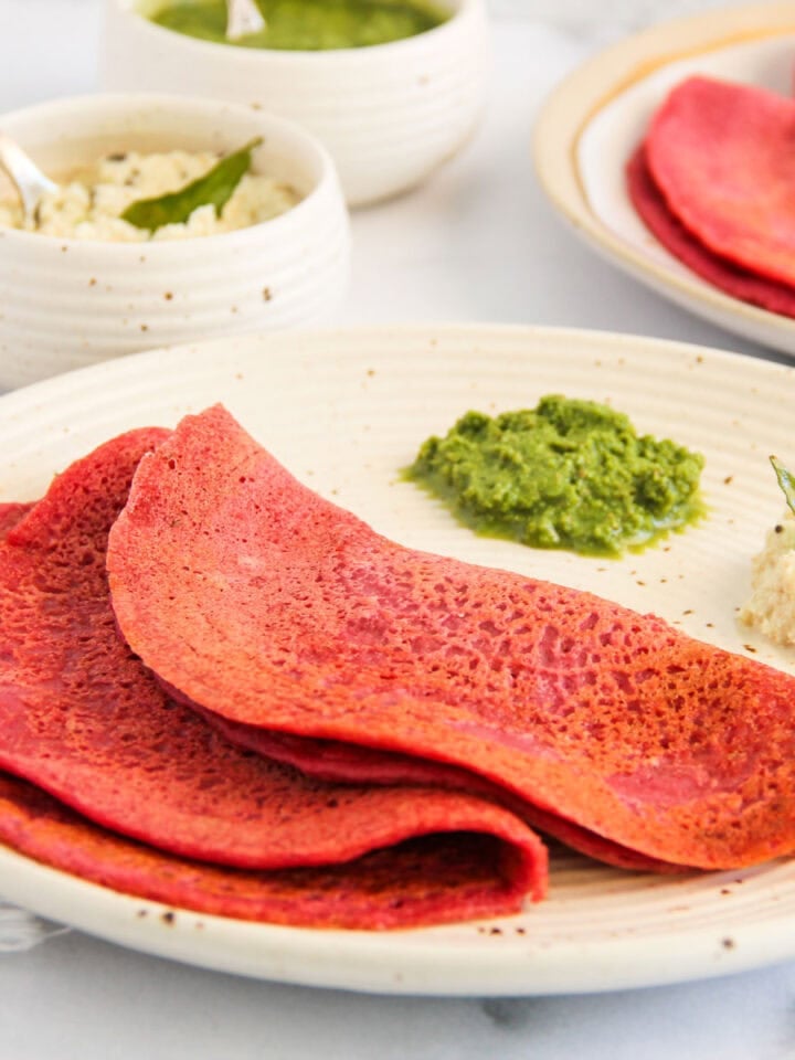 beet chillas served with cilantro chutney and coconut chutney.