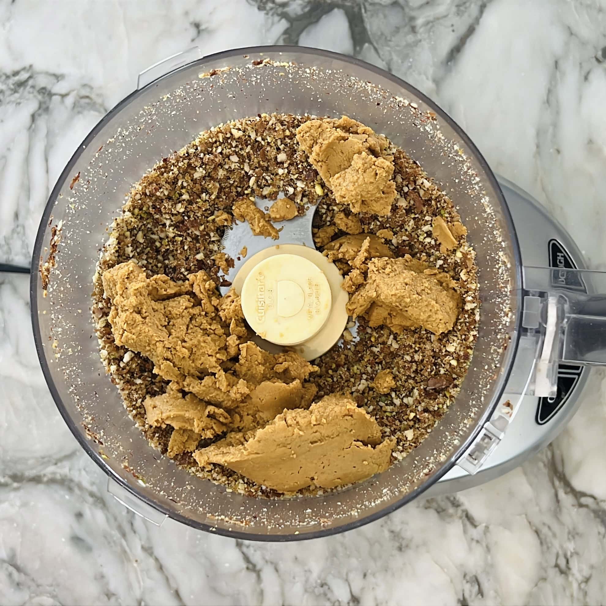 roasted sattu atta added to ground nut powder in food processor.