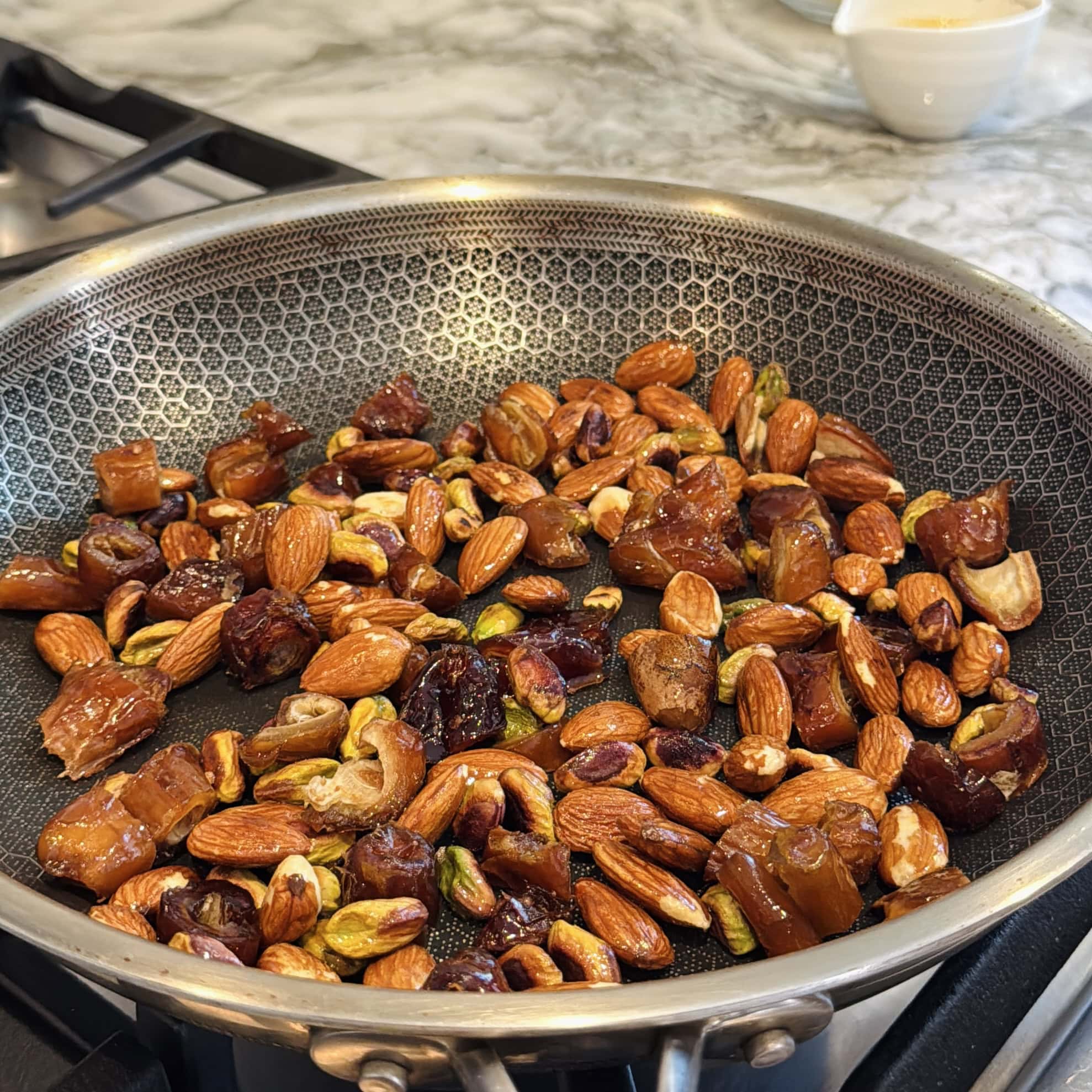 roasting chopped dates, almonds and pistachios in ghee