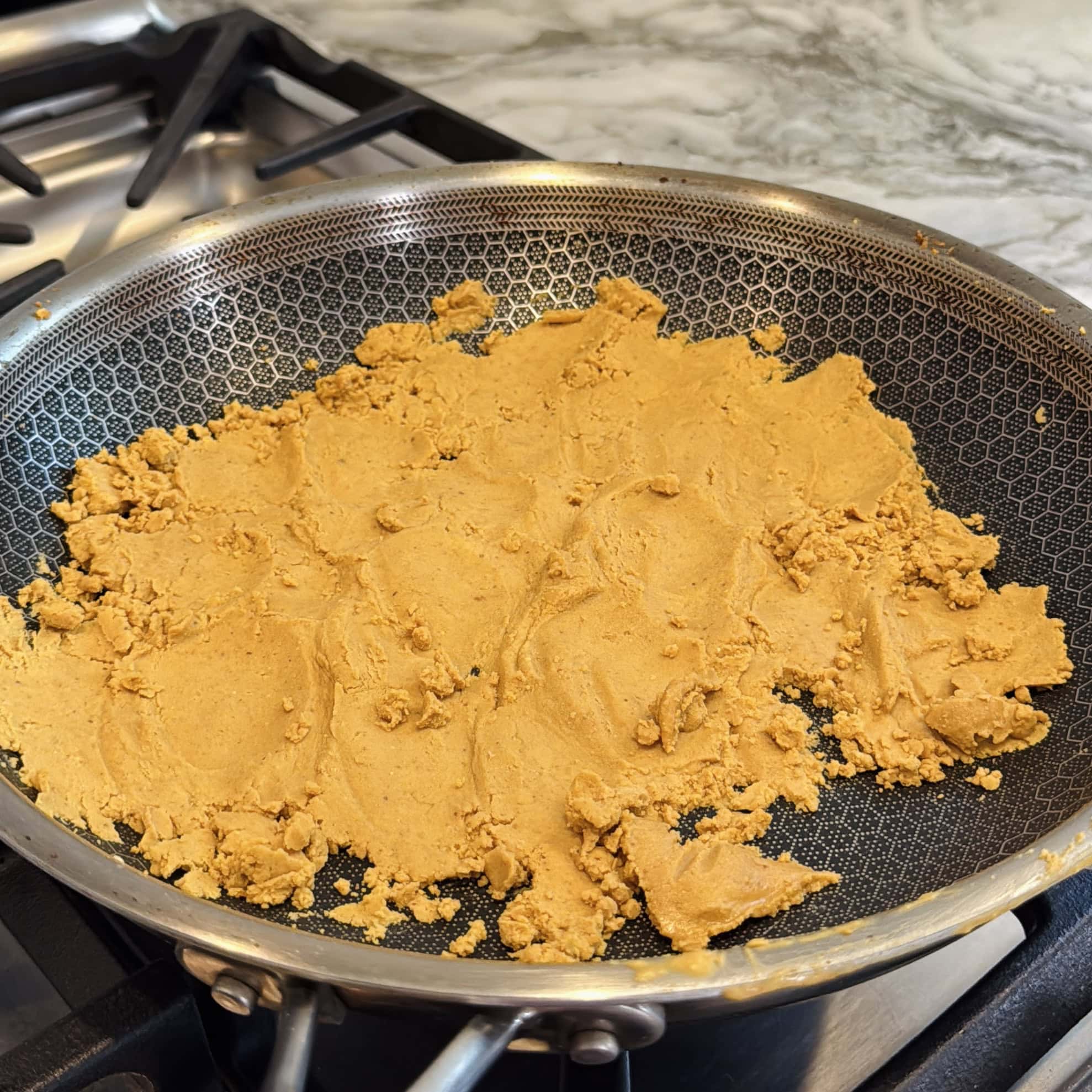 roasted sattu atta in a non stick frying pan.
