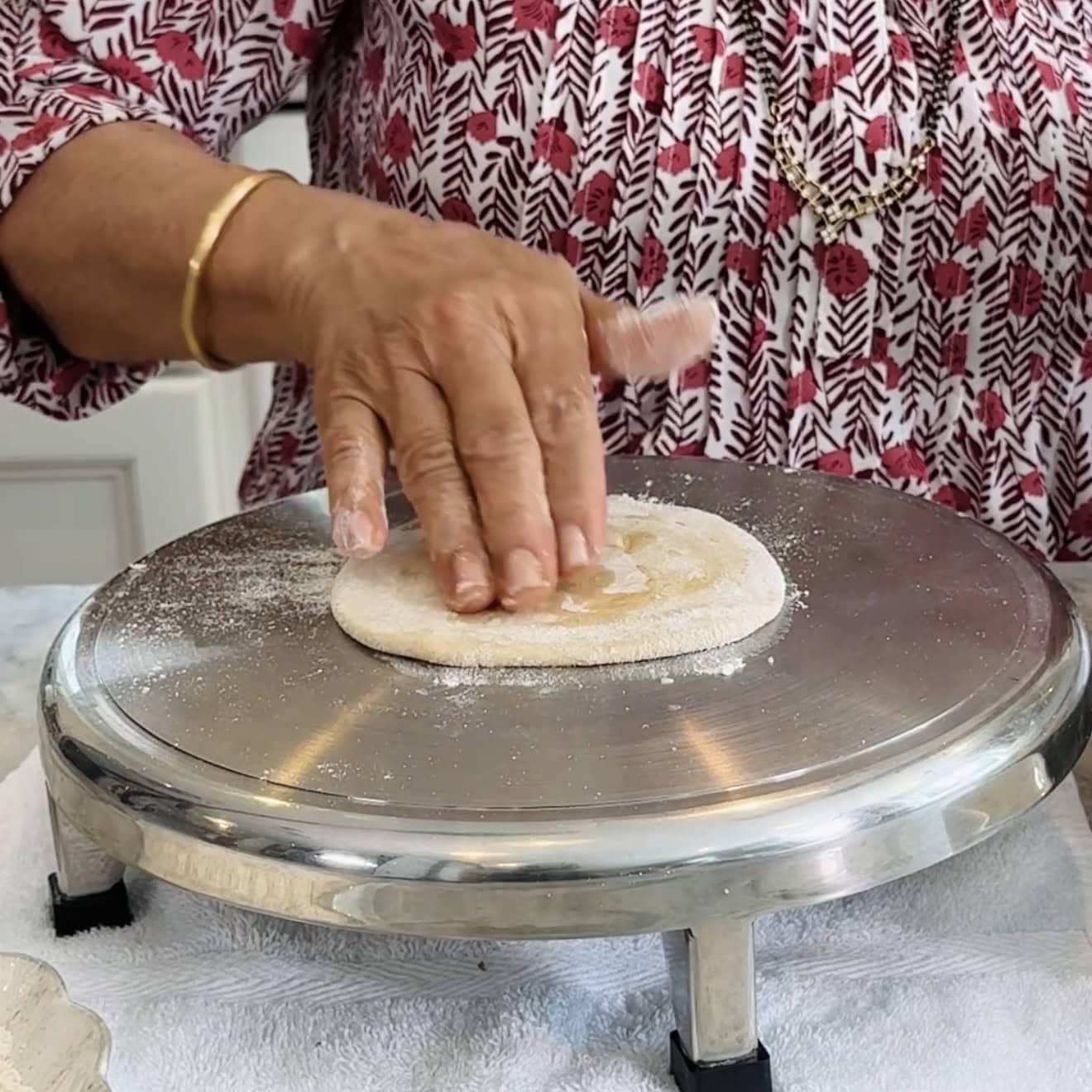 Adding flour and oil to rolled dough.