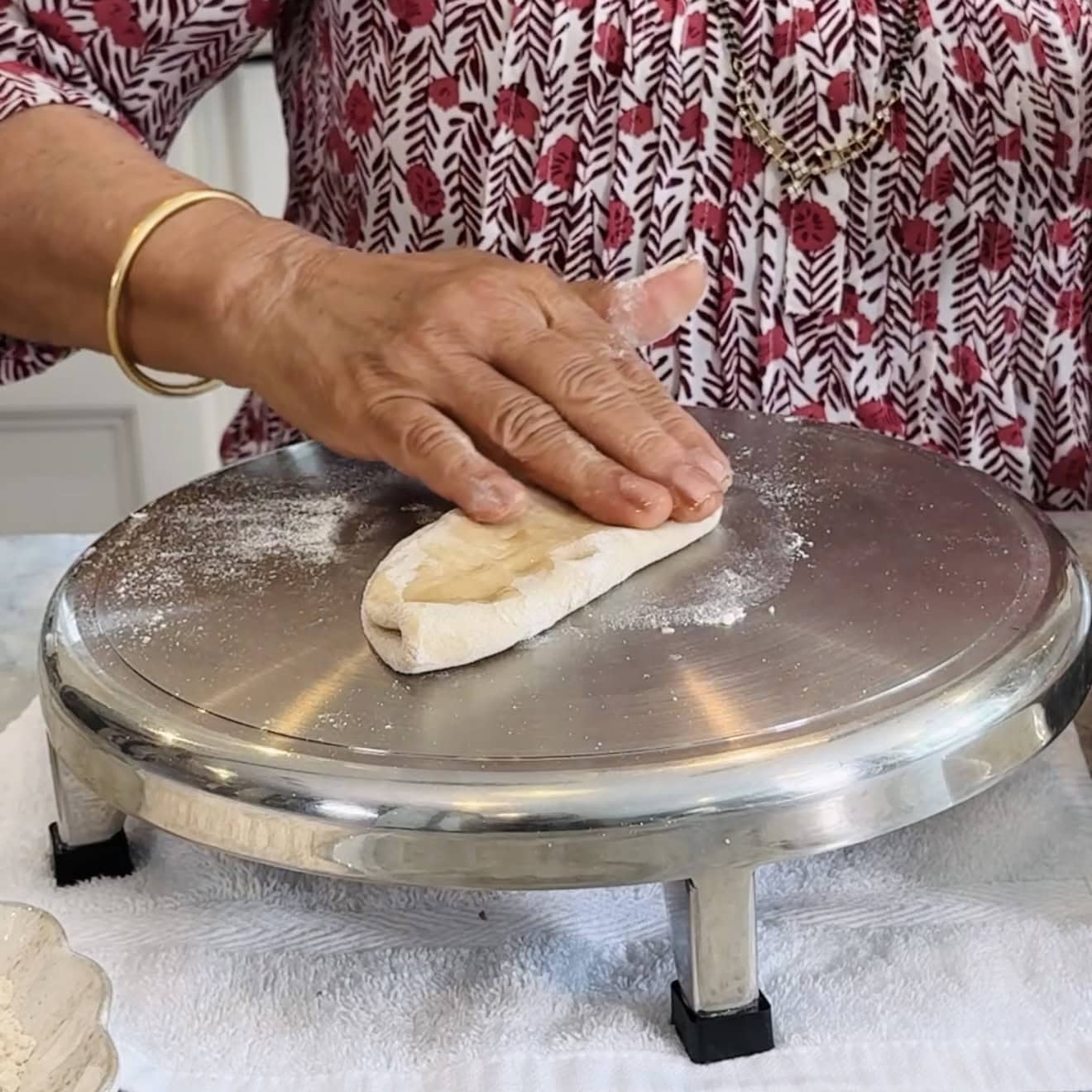 Adding flour and oil to rolled dough.