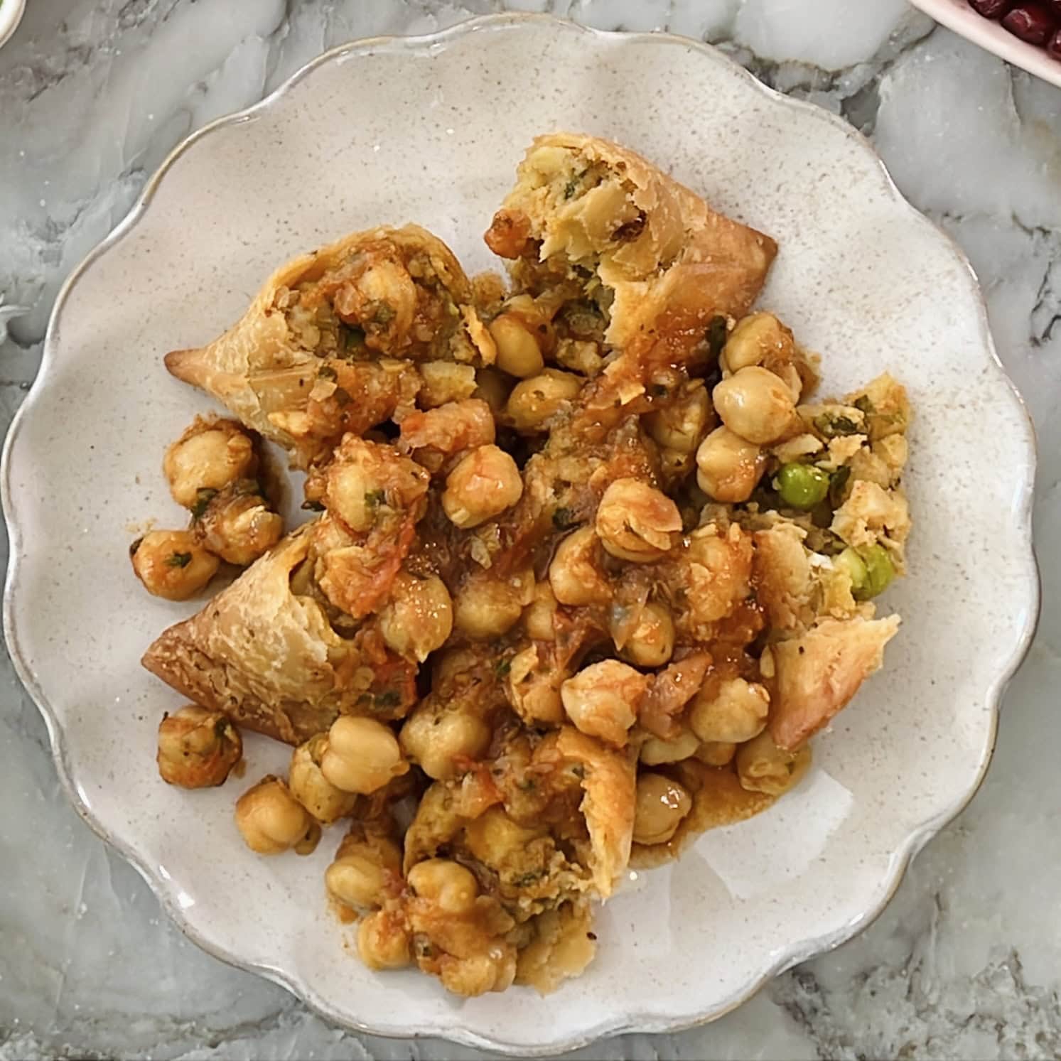 samosas topped with chana masala.