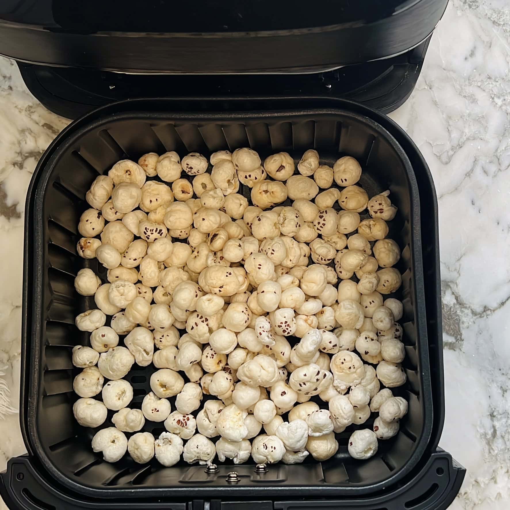 makhana in airfryer basket.