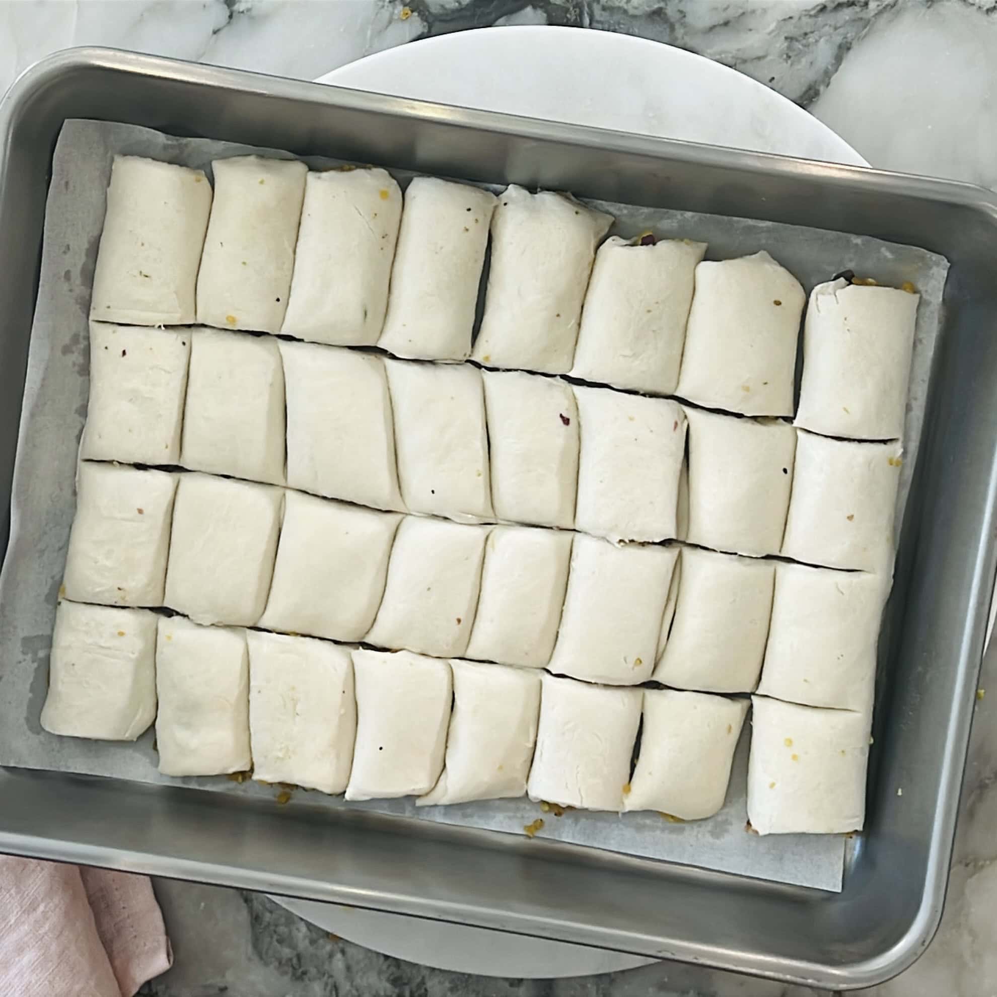 filled puff pastry rolls cut into sqaures.