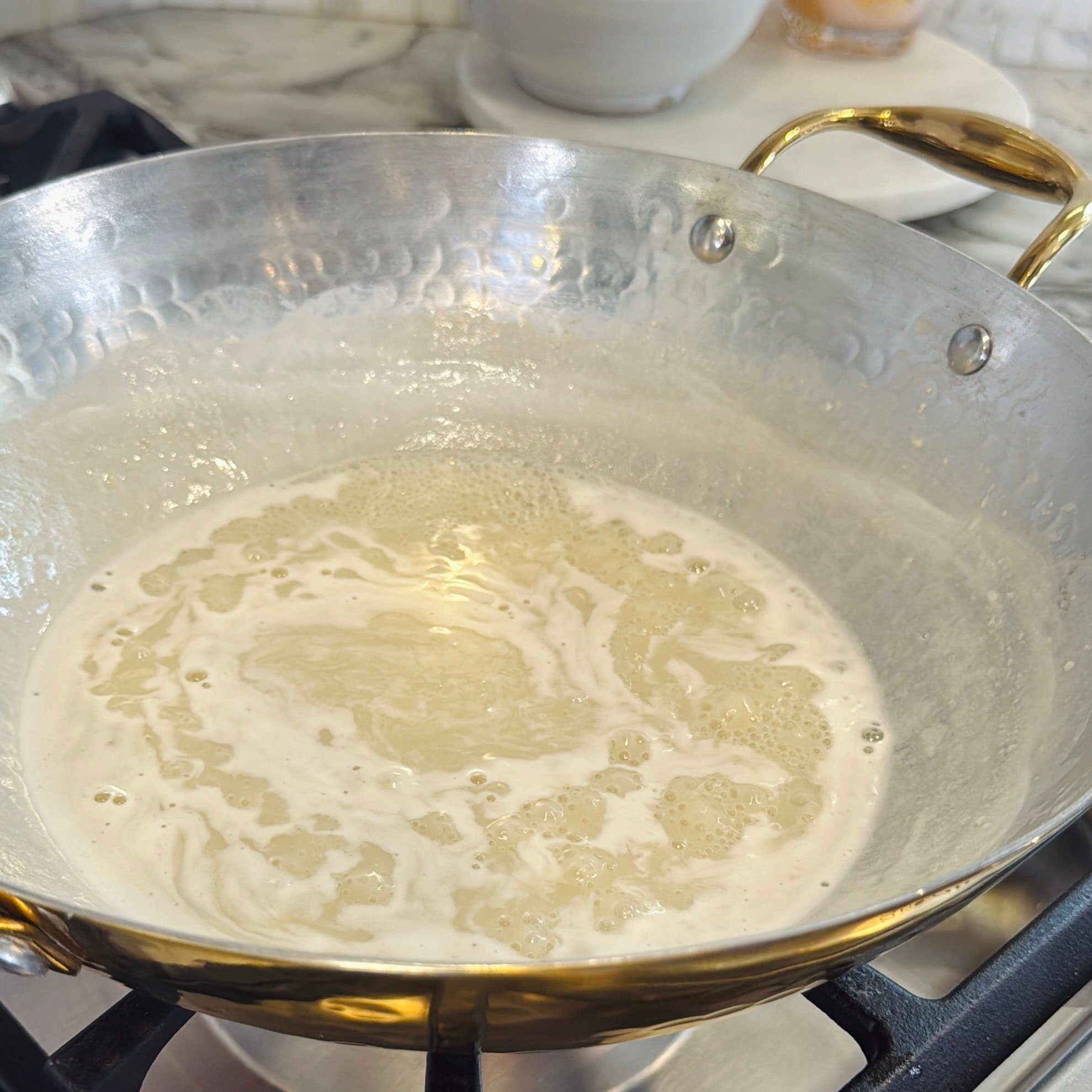 simmering milk and sugar in a pan.