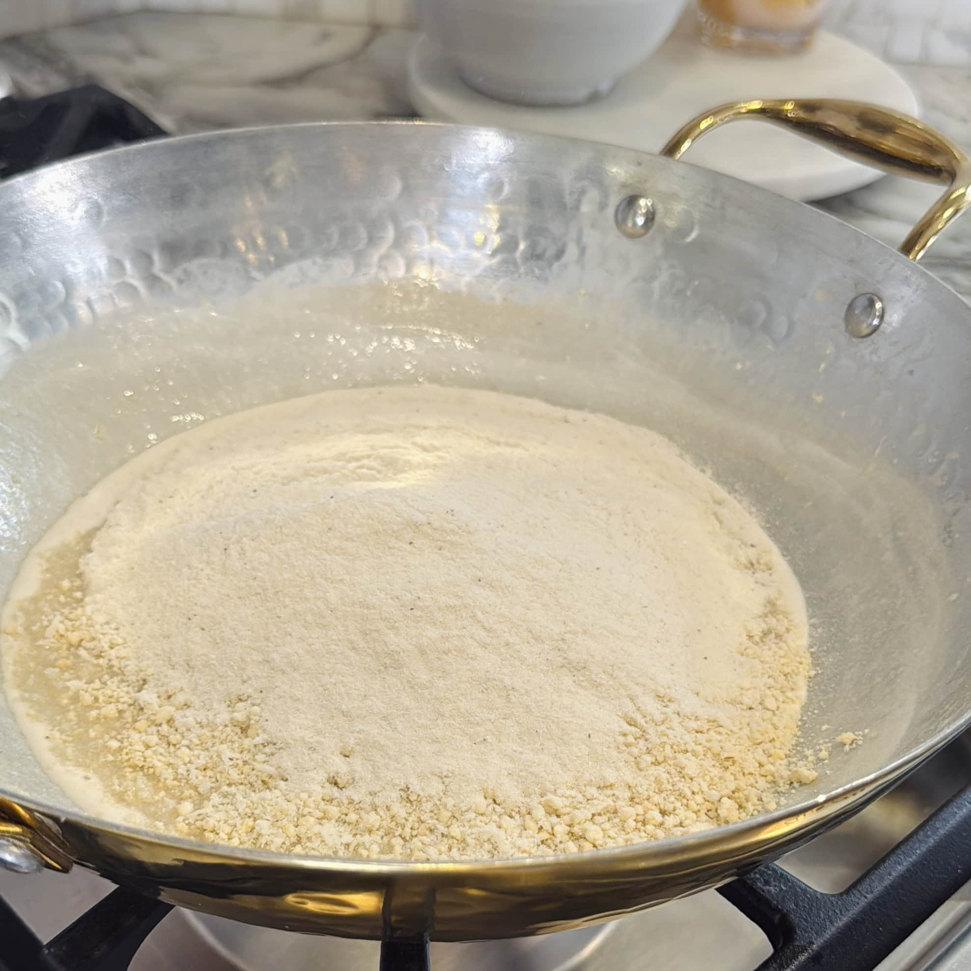 makhana, cashew and coconut powder added to kadhai. 