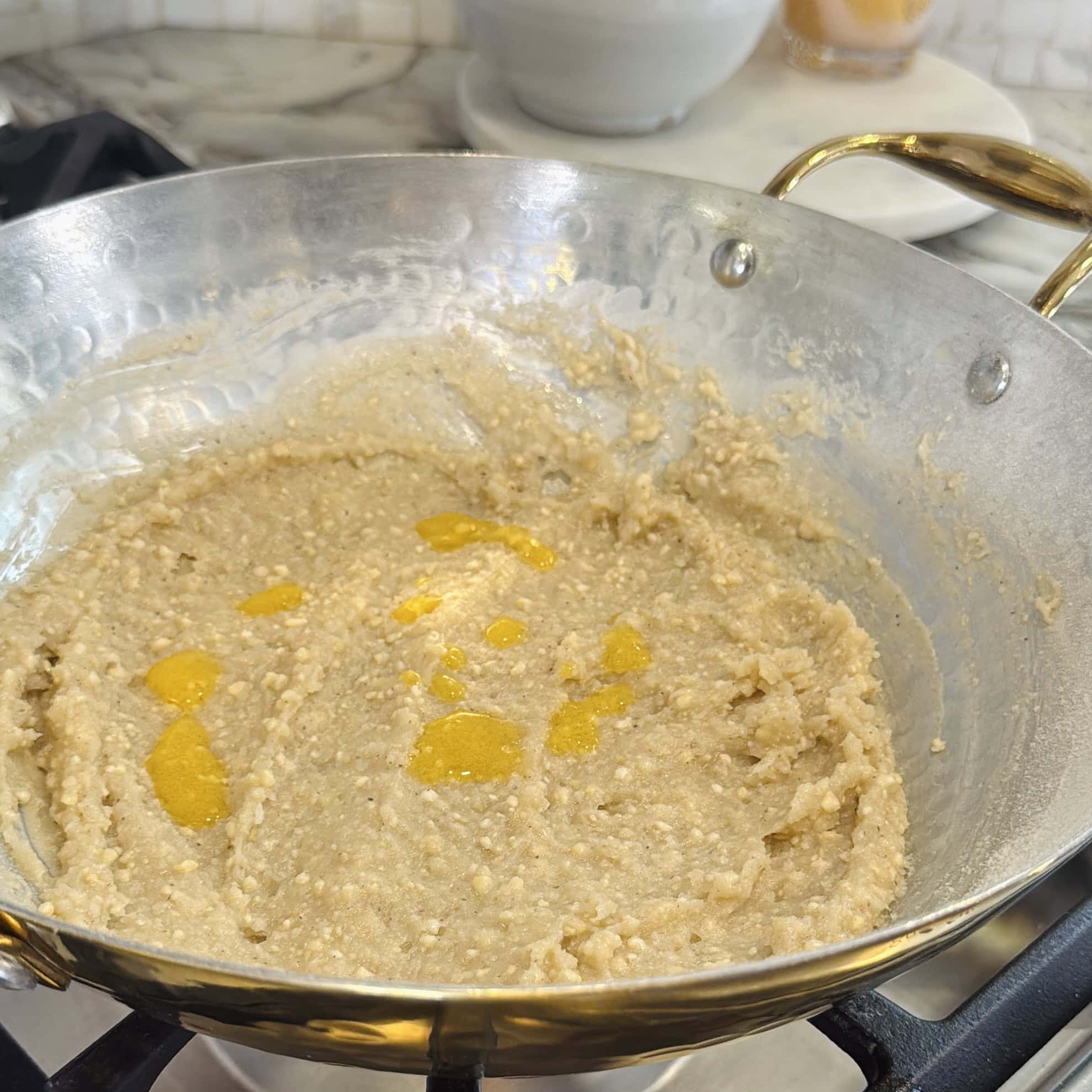 thickened burfi mixture with ghee on top.
