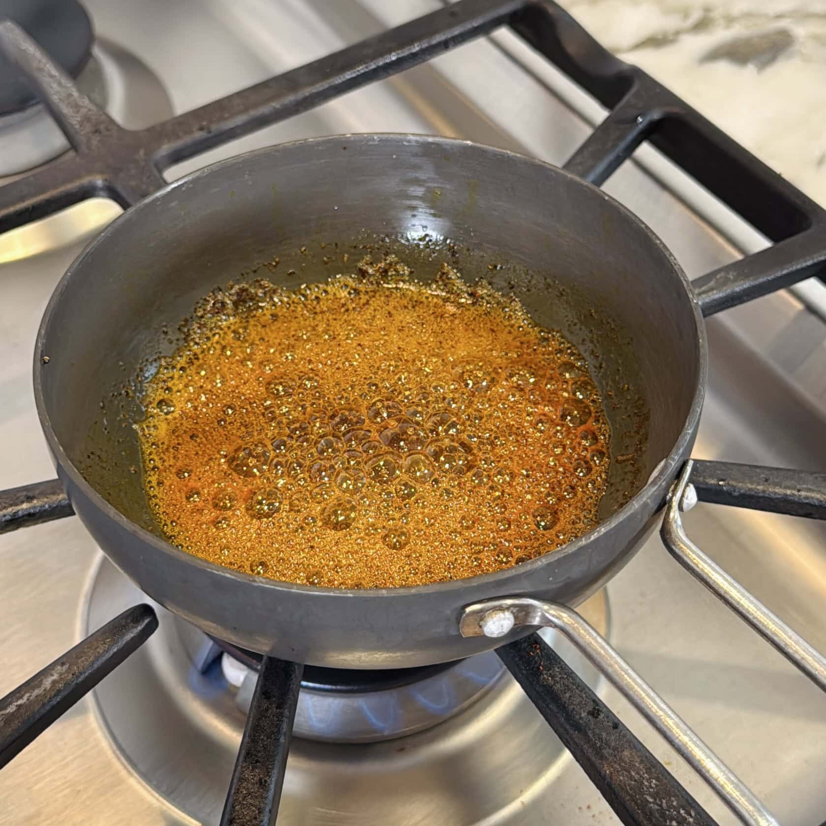 tempered spices in a small pan.