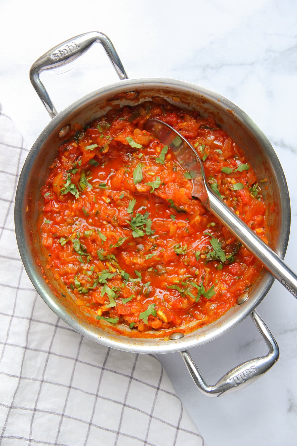 tomato chutney in a stainless steel pan.