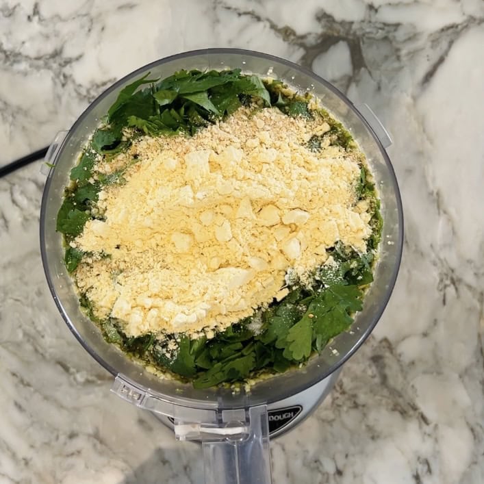 besan and breadcrumbs added to food processor jar.