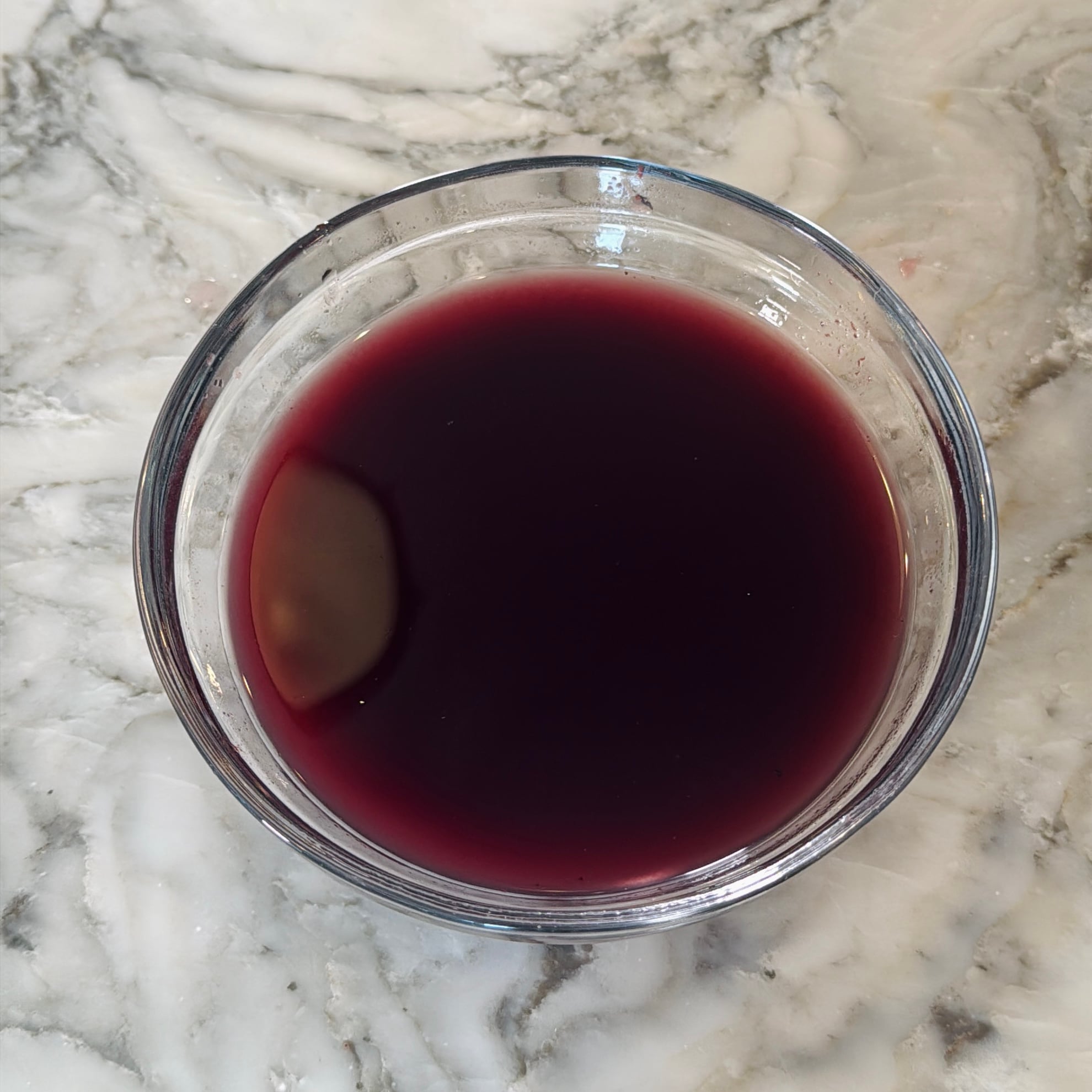 A clear glass bowl with water and kokum rinds.