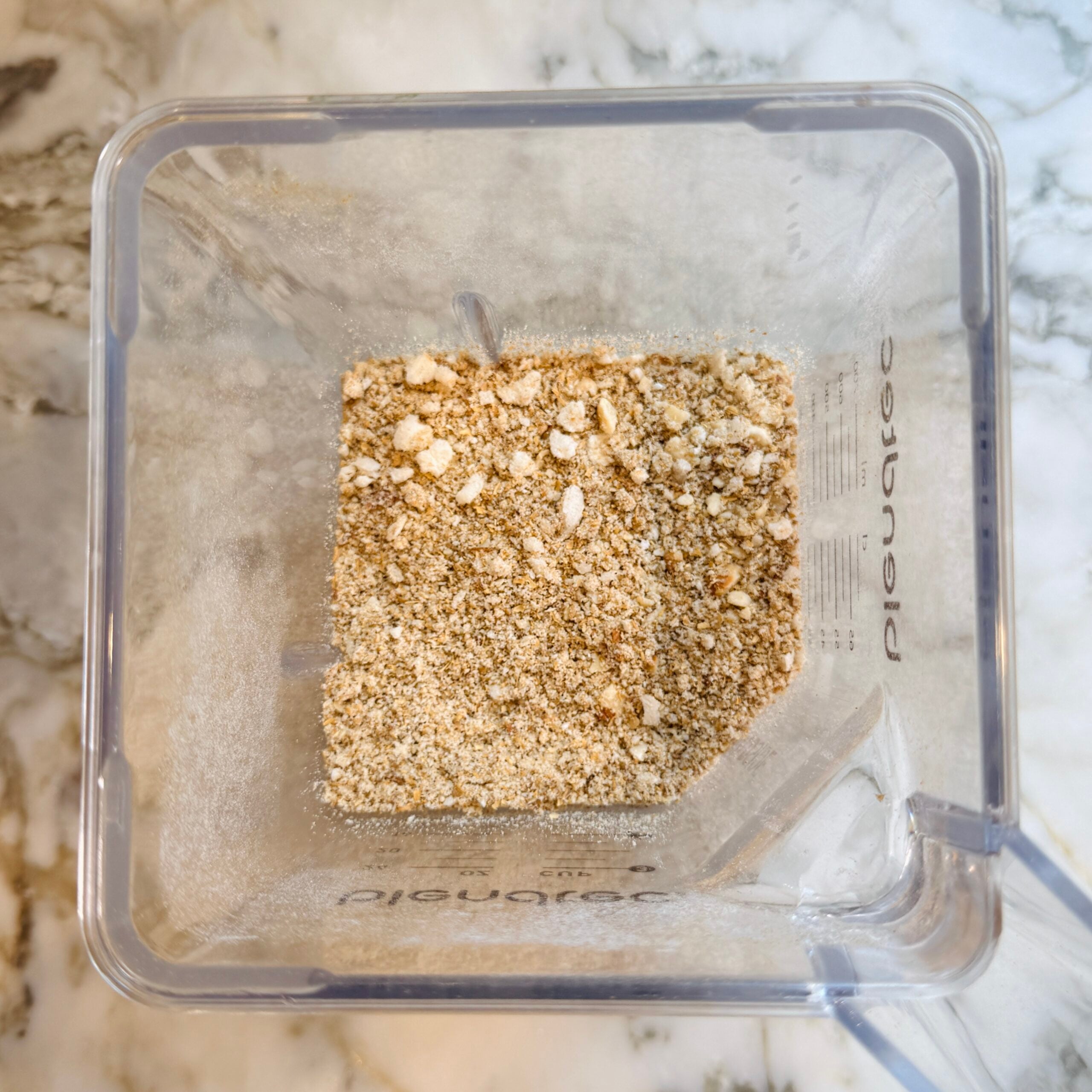 Blender with partially ground nuts and coconut.